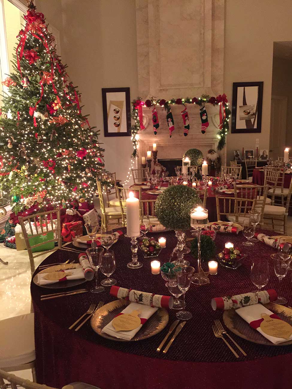 Tabletop Christmas dinner design with silverware, dinnerware and a Christmas tree in the background