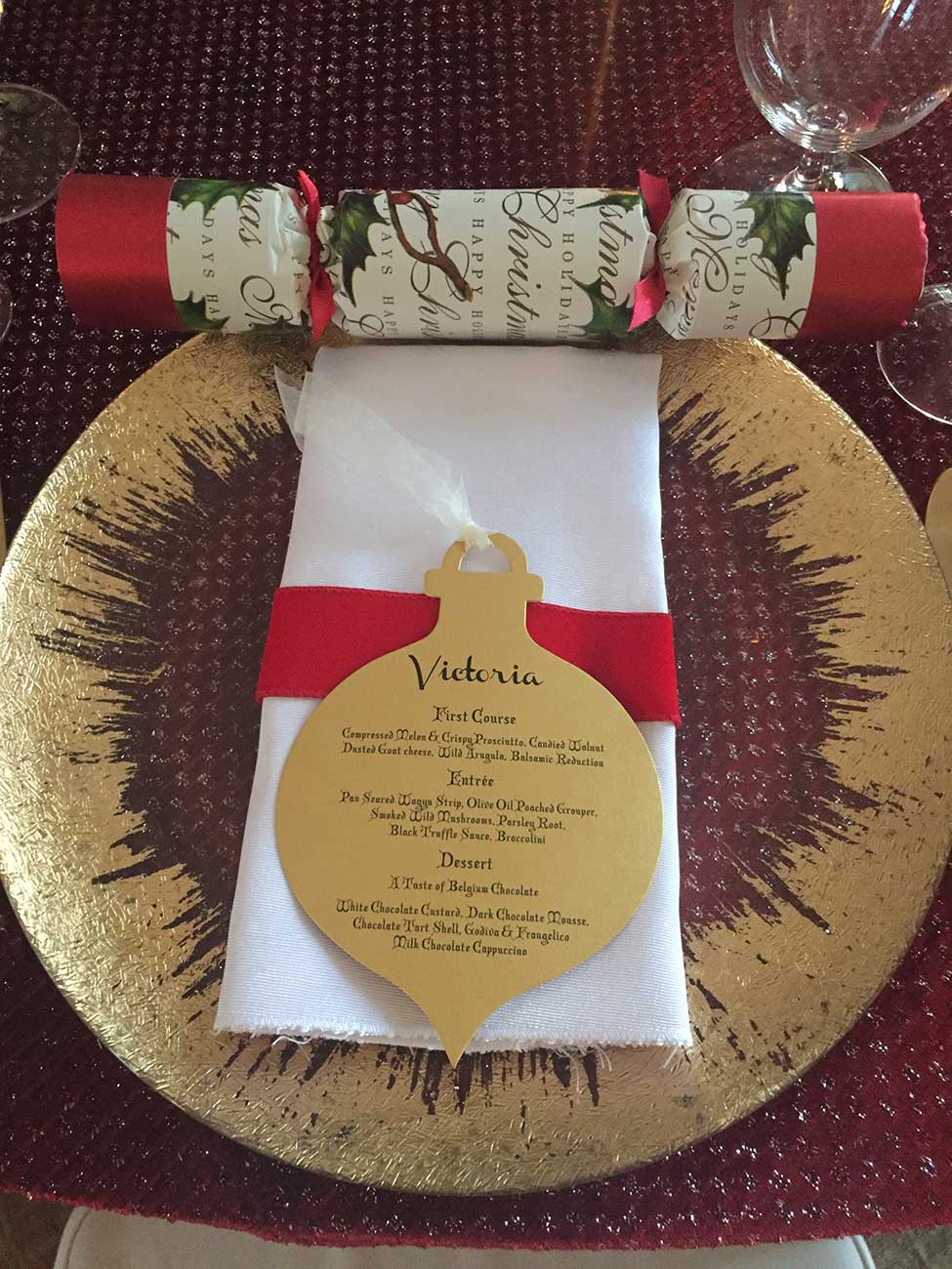 Gold menu card in a Christmas design over a gold charger