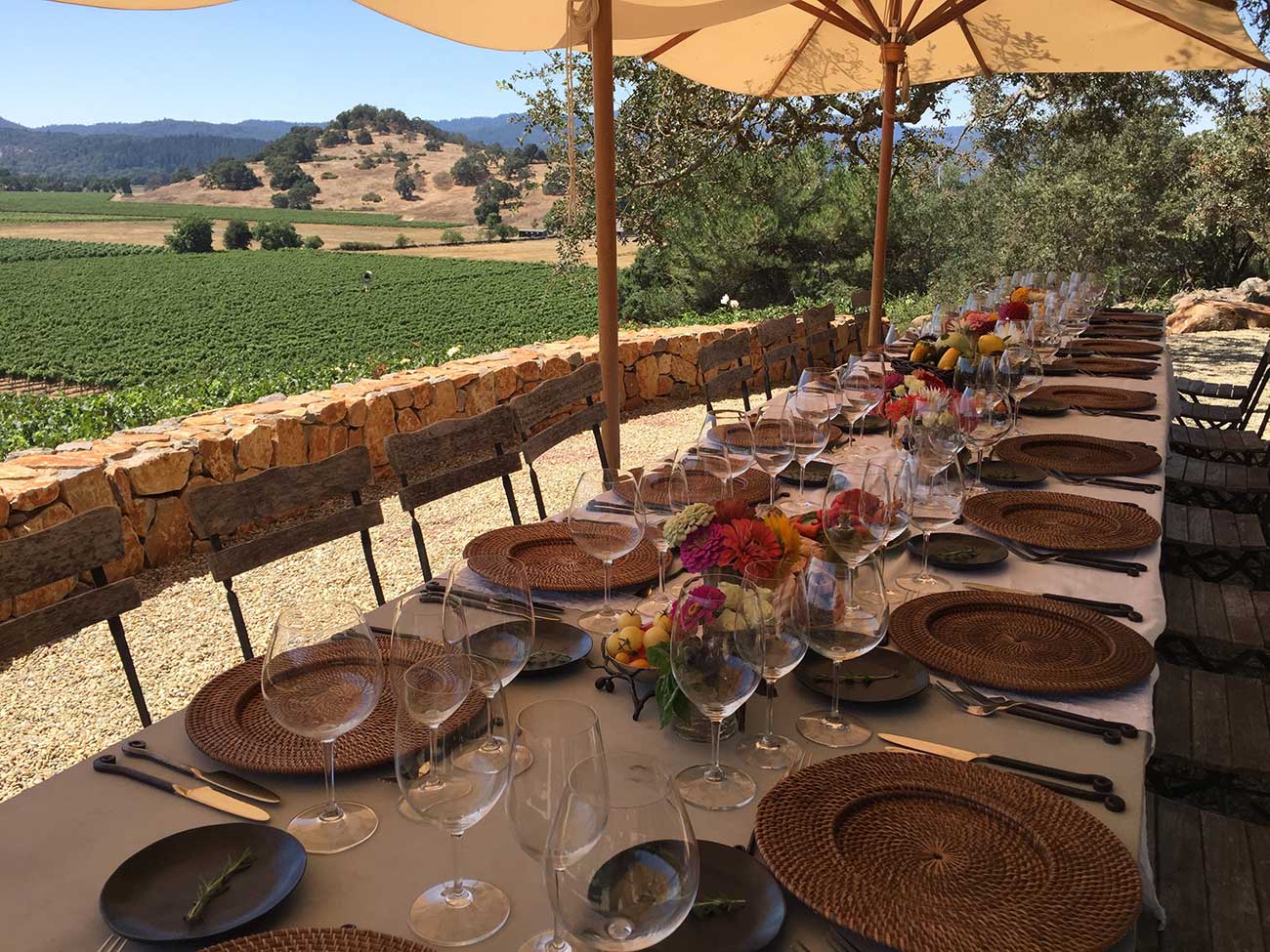 Tabletop design with crystal and flowers overlooking a vineyard in Napa valley