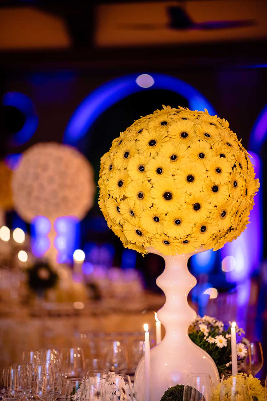 Yellow daisies in a white vase tabletop design for Naples Wine Festival Hamel
