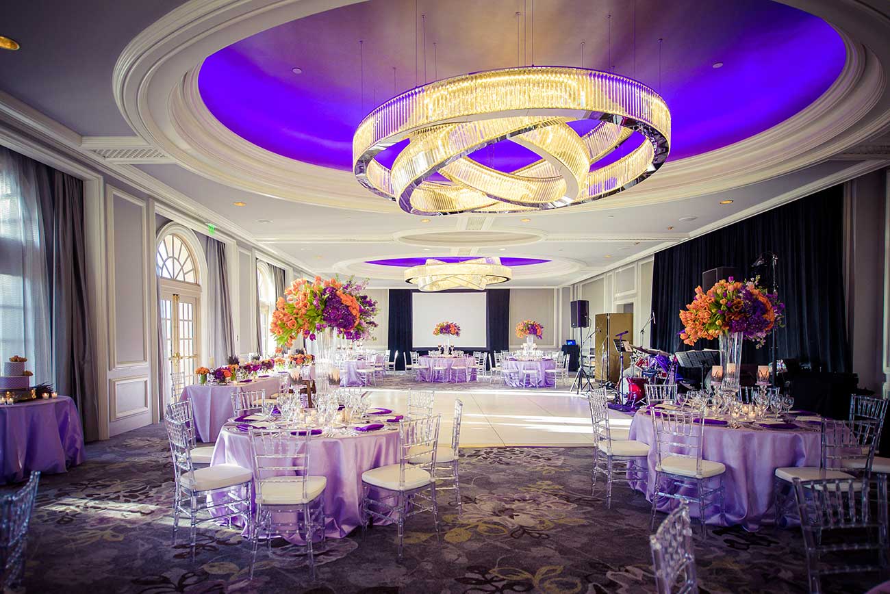 Reception room with tabletop designed linens, crystal, florals and dinnerware